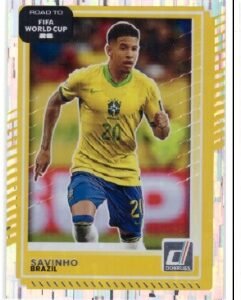 Savinho #186 trading card from the 2025-26 Panini Donruss Road to FIFA World Cup collection, featuring the Brazilian player in a yellow and blue kit.